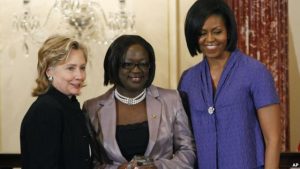 FILE - First lady Michelle Obama and Secretary of State Hillary Rodham Clinton present the 2010 International Women of Courage Award to Jestina Mukoko of Zimbabwe on March 10, 2010, at the State Department in Washington.
