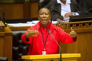 Julius Malema, pictured addressing the country's parliament during a debate on April 5 in Cape Town, and his Economic Freedom Fighters are shaking up South African politics. RODGER BOSCH/AFP/GETTY IMAGES