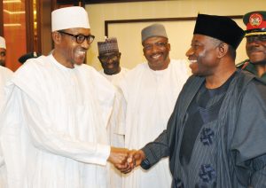 PRESIDENT-ELECT RETIRED MAJ.-GEN. MUHAMMADU BUHARI (L) IN A HANDSHAKE WITH PRESIDENT GOODLUCK JONATHAN DURING HIS OFFICIAL VISIT TO THE PRESIDENTIAL VILLA IN ABUJA ON FRIDAY (24/4/15).WITH THEM IS THE FORMER CHIEF OF ARMY STAFF,RETIRED LT.-GEN. ABDUHRAMAN DAMBAZAU. 