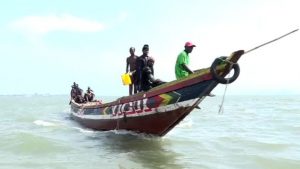 The wooden canoes of Guinea's fishermen are dwarfed by Chinese trawlers