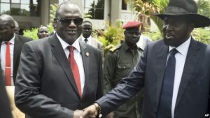 South Sudan's First Vice President Riek Machar, left, and President Salva Kiir, right, shake hands following the first meeting of a new transitional coalition government, in the capital Juba, April 29, 2016.