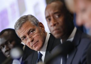 Actors George Clooney, left center, and Don Cheadle, right, during a press conference to discuss an investigation about corruption in South Sudan at the National Press Club in Washington, Monday, Sept. 12, 2016. (AP Photo/Pablo Martinez Monsivais)