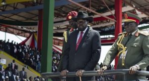 FILE - South Sudan's President Salva Kiir, center, accompanied by army chief of staff Paul Malong, right, attends an independence day ceremony in the capital Juba, South Sudan, July 9, 2015.