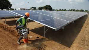 FILE - In this photo taken June 30, 2016, a Ugandan worker levels the ground at a solar plant in Soroti about 300 kilometers east of Uganda capital Kampala.