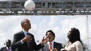 FILE - U.S. President Barack Obama bounces a soccer ball with his head at Ubungo Power Plant in Dar es Salaam, July 2, 2013. The ball, called a "soccket ball," has internal electronics that allow it to generate and store electricity that can power small devices.