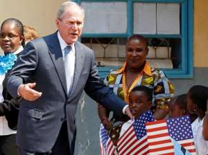 Former US President George W. Bush greets children at a school in Gaborone, Botswana, April 4, 2017.  REUTERS/Mike Hutchings