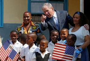 Former US President George W. Bush greets children at a school in Gaborone, Botswana, April 4, 2017.  REUTERS/Mike Hutchings