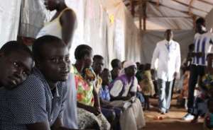  Two South Sudanese teenagers wait in queue to see a doctor at Bidi Bidi Refugee Camp.
