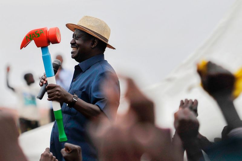 Kenya's opposition leader Raila Odinga holds a mock hammer bearing the initials of NASA, the opposition National Super Alliance party, as he cheers supporters during a political rally on September 3, 2017 in the Nairobi suburb of Huruma. Sparks were flying in Kenya on September 3 as the main rival of President Uhuru Kenyatta called for the ousting of members of the country's election commission, likening them to "hyenas", while judges slammed "veiled threats" by the president after the shock annulment of his re-election victory. / AFP PHOTO / TONY KARUMBA (Photo credit should read TONY KARUMBA/AFP/Getty Images)