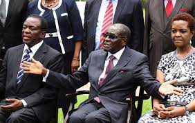 Zimbabwe's President Robert Mugabe sits with his wife Grace Mugabe and Vice President Emmerson Mnangagwa