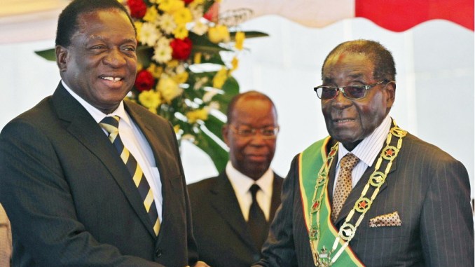 President Robert Mugabe (R) greets Vice President Emmerson Mnangagwa as he arrives for Zimbabwe's Heroes Day commemorations in Harare, August 10, 2015. REUTERS/Philimon Bulawayo