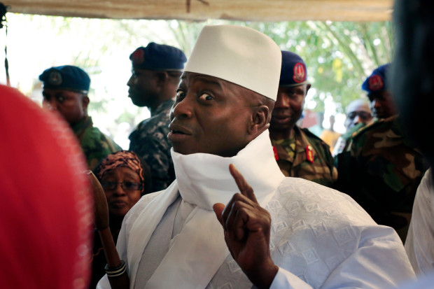 FILE - In this Thursday, Dec. 1, 2016 file photo, Gambia's President Yahya Jammeh shows his inked finger before voting in Banjul, Gambia. Jammeh took power in 1994 in a bloodless coup, ruling the tiny West African nation for more than 22 years. His regime was accused of overseeing human rights abuses to silence opponents. (AP Photo/Jerome Delay, File)