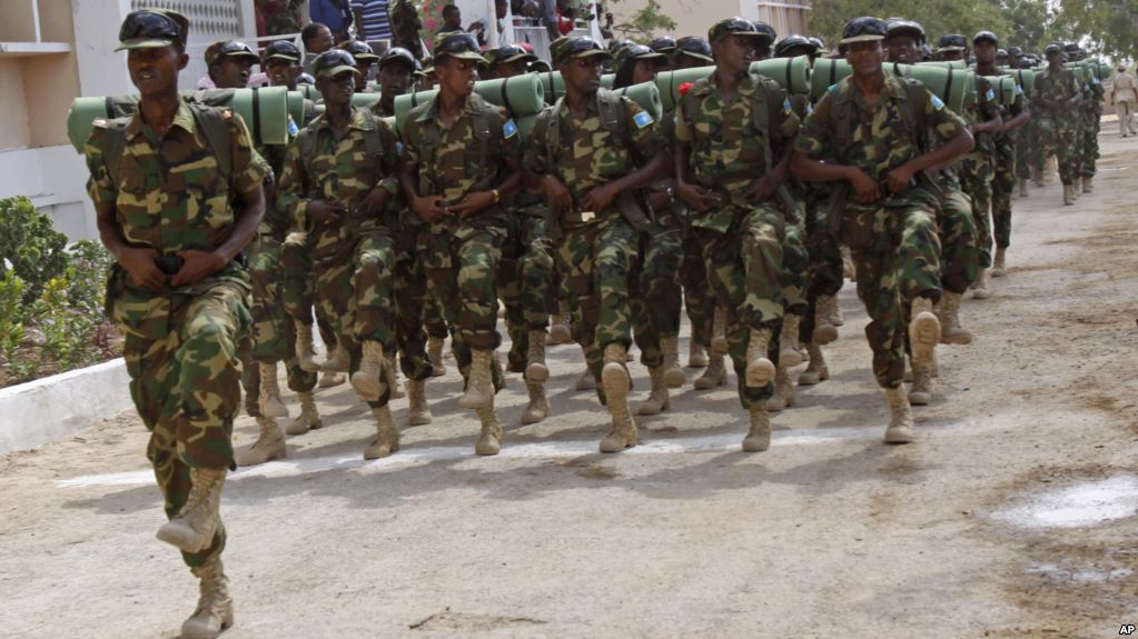 FILE - Somali soldiers march during the 54th anniversary of Somali National Army Day in Mogadishu, Somalia.