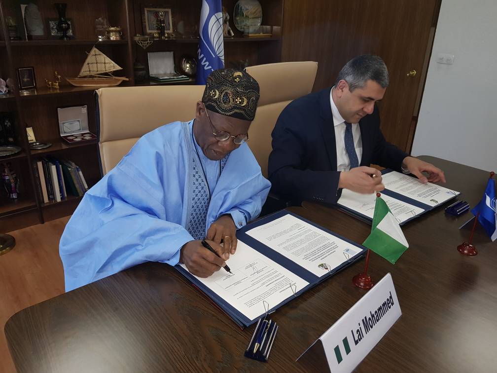 Minister of Information and Culture, Alhaji Lai Mohammed, and the UNWTO's Secretary-General, Mr. Zurab Pololikashvili, signing the Agreement on Nigeria's hosting of the 61st CAF Meeting, in Madrid, Spain, on Friday