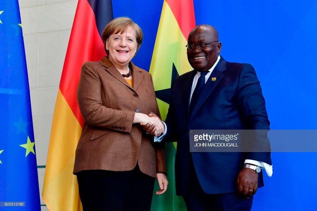 German Chancellor Angela Merkel shakes hands with Ghana's President Nana Akufo-Addo (R)