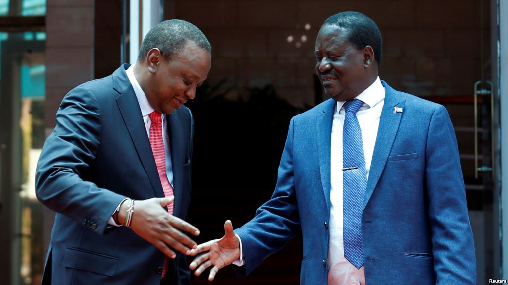 Kenya's President Uhuru Kenyatta, left, and opposition leader Raila Odinga of the National Super Alliance (NASA) coalition shake hands after a joint news conference in Nairobi, March 9, 2018.