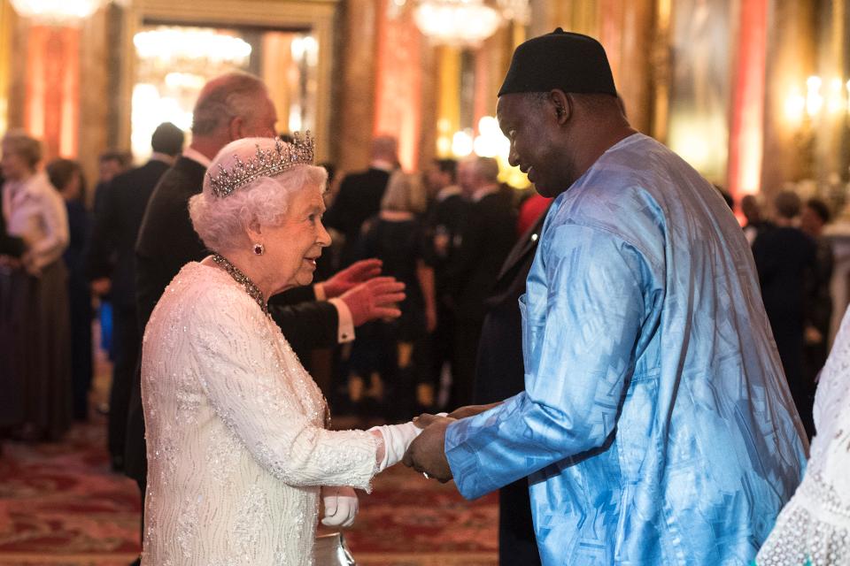 Queen Elizabeth II greets Adama Barrow, Gambia's President, in the Blue Drawing Room. He wore the right color for the occasion. (Photo by Victoria Jones - WPA Pool/Getty Images)