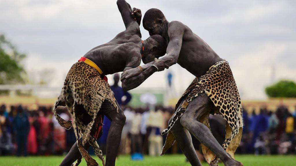 Wrestlers from Jonglei and eastern lakes region take part in the South Sudan national wrestling competition for peace at Juba stadium, South Sudan, on April 20, 2016. South Sudan is holding a “wrestling for peace” tournament, bringing together athletes from around the country. Carl de Souza/AFP
