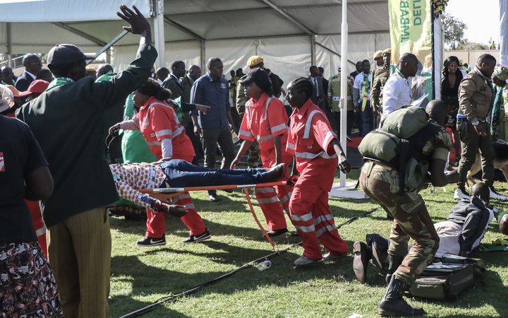 Injured people are evacuated after an explosion at the stadium in Bulawayo where Zimbabwe President addressed a rally. Photo: AFP