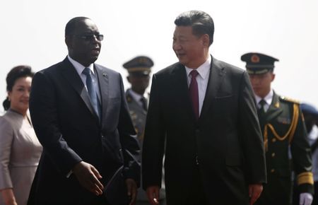 Chinese President Xi Jinping walks with Senegal's President Macky Sall after arriving at the Leopold Sedar Senghor International Airport, at the start of his visit to Dakar, Senegal July 21, 2018. REUTERS/Mikal McAllister