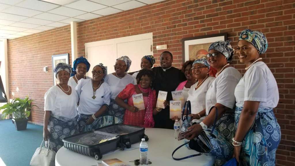 Father Wilfred Emeh with Catholic Women Association members after a recent event to launch the book in the USA