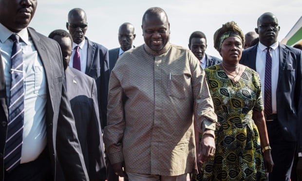  Riek Machar, former vice-president of South Sudan, arrives at Juba international airport with his wife, ending two years in exile. Photograph: Akuot Chol/AFP/Getty Images